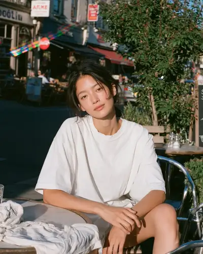 Golden-hour cafe portrait with rainbow lens flare