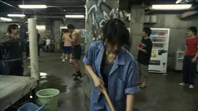 Young Japanese cleaner character in faded blue janitor uniform