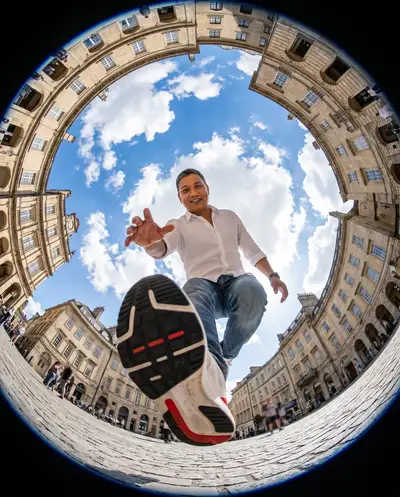 Fisheye tiny-planet street photo with a person stepping over the camera