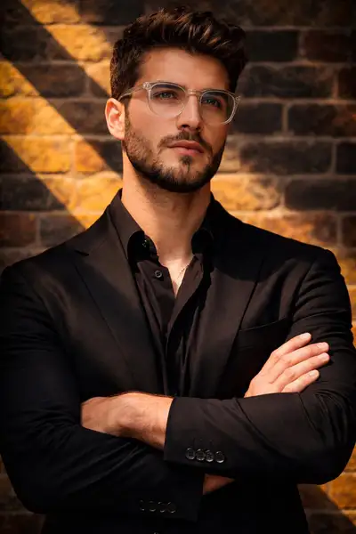 Cinematic Portrait of Confident Man by Brick Wall