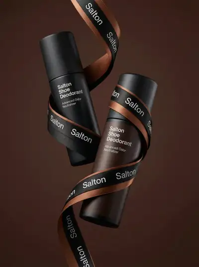 Levitating twin bottles of shoe deodorant with satin ribbon branding
