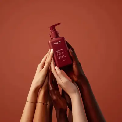 Minimalist product shot of a lubricant bottle held by diverse hands