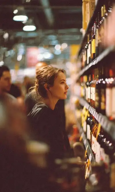 Cinematic side-profile portrait of a woman shopping for wine