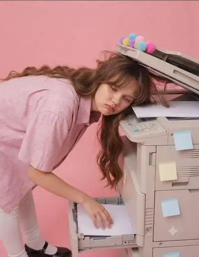 Surreal pink studio portrait leaning on an office copier