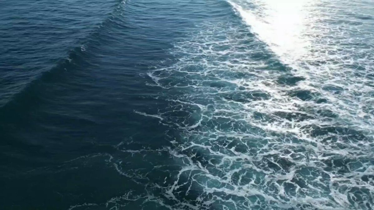 Two ocean waves meeting, aerial Veo 3 JSON prompt