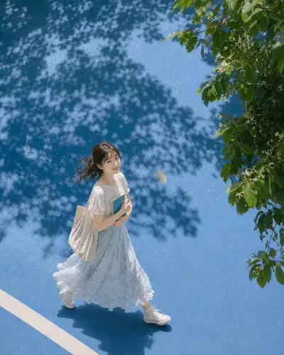 Blue pavement portrait with leaf shadows and a floating leaf