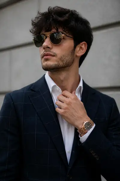 Editorial portrait with windowpane blazer and gold aviators