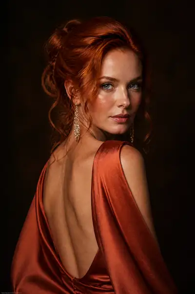 Terracotta satin gown over-the-shoulder editorial portrait