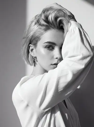 Black-and-white high-fashion editorial portrait, arm raised