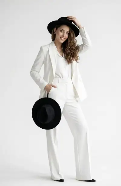 White pantsuit studio portrait with hat and heels variations
