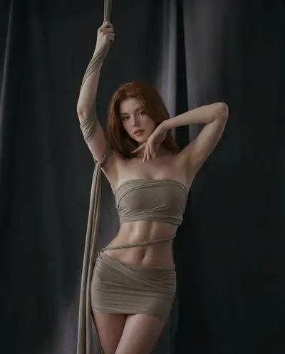 Studio portrait against dark curtains editorial fashion