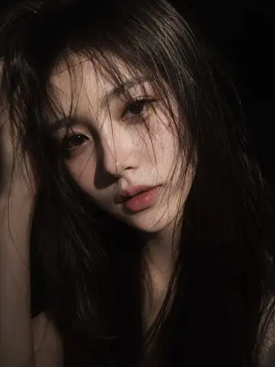 Moody low-key close-up portrait of an East Asian woman