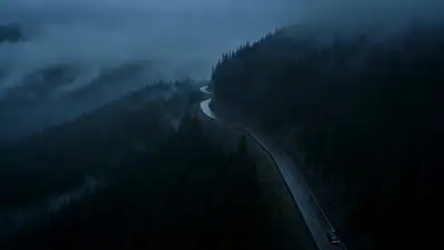 Vintage Black Car Racing Through Rainy Mountain Road at Dusk