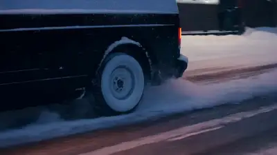 Lateral Close-Up of Van Skidding on Snow