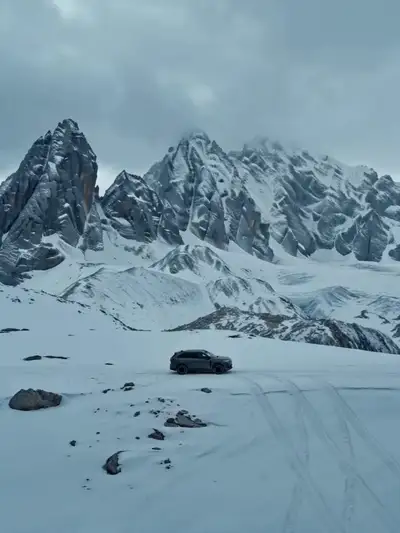 Cinematic Dance on SUV in Snowy Mountains