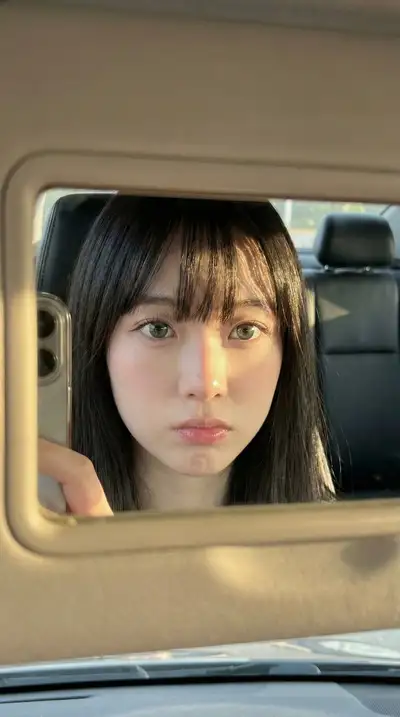Golden-hour car sun-visor mirror selfie
