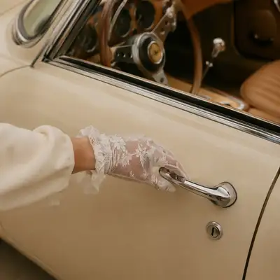 Lace glove and vintage car door handle lifestyle photo