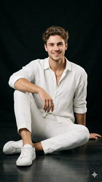 Studio Portrait Series of Man in White Linen With Vintage Camera