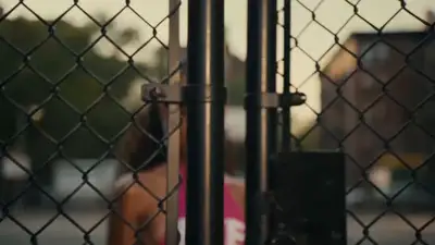 Music video segment 3: rapper on a caged NYC basketball court