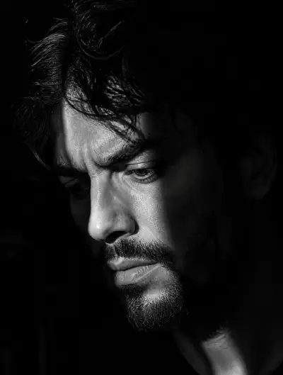 Moody black and white portrait with a single light beam