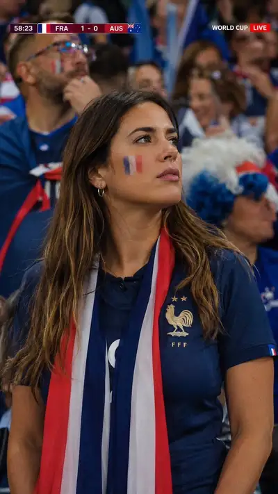 Live broadcast cutaway of a France football fan in the stands