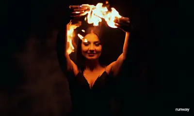 Woman Manipulating Flames in Black Dress