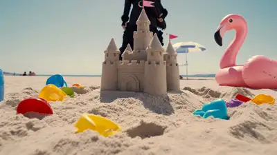 Gothic figure crushes a sand castle on a bright beach