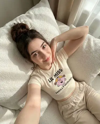 Playful iPhone-style selfie with a messy bun