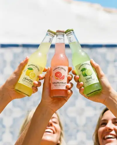 Three hands holding drink bottles, four beverage concepts