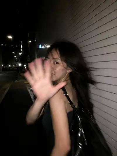 Candid Flash Photo of Woman Blocking Camera on Tokyo Street
