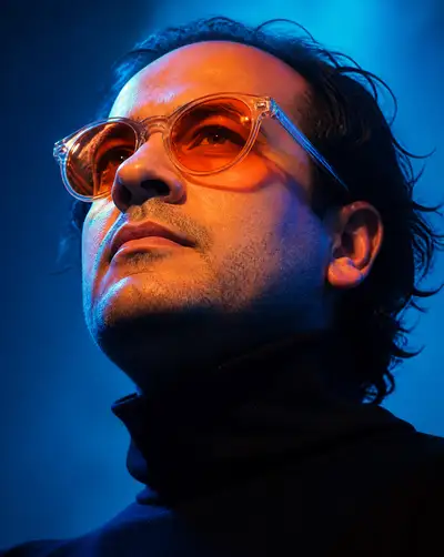 Cyberpunk neon low-angle portrait with orange sunglasses