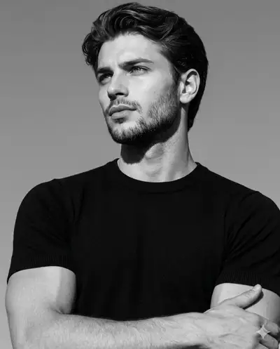 High-contrast black and white editorial portrait of a man