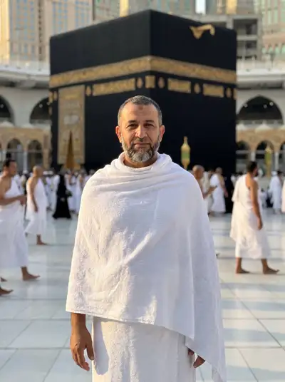 Pilgrim portrait in front of the Kaaba in Mecca