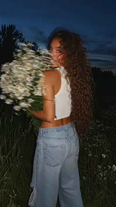 Foto candida en un prado de verano con ramo de margaritas
